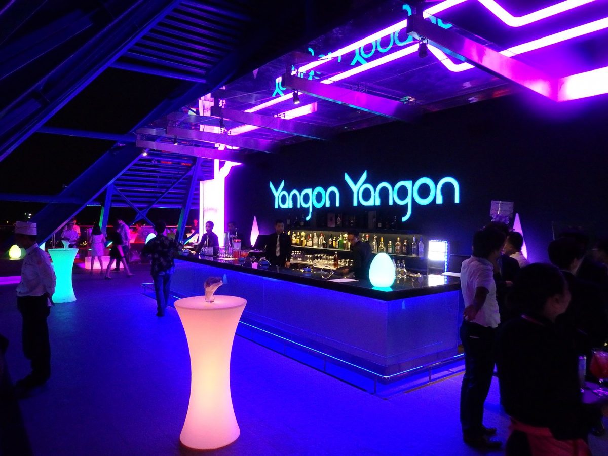 a nightclub at Yangon with neon lights and illuminated tables
