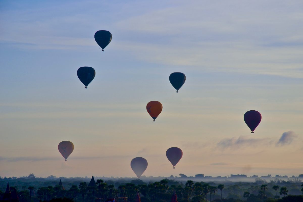 hot air balloons fly in the skies of Bagan