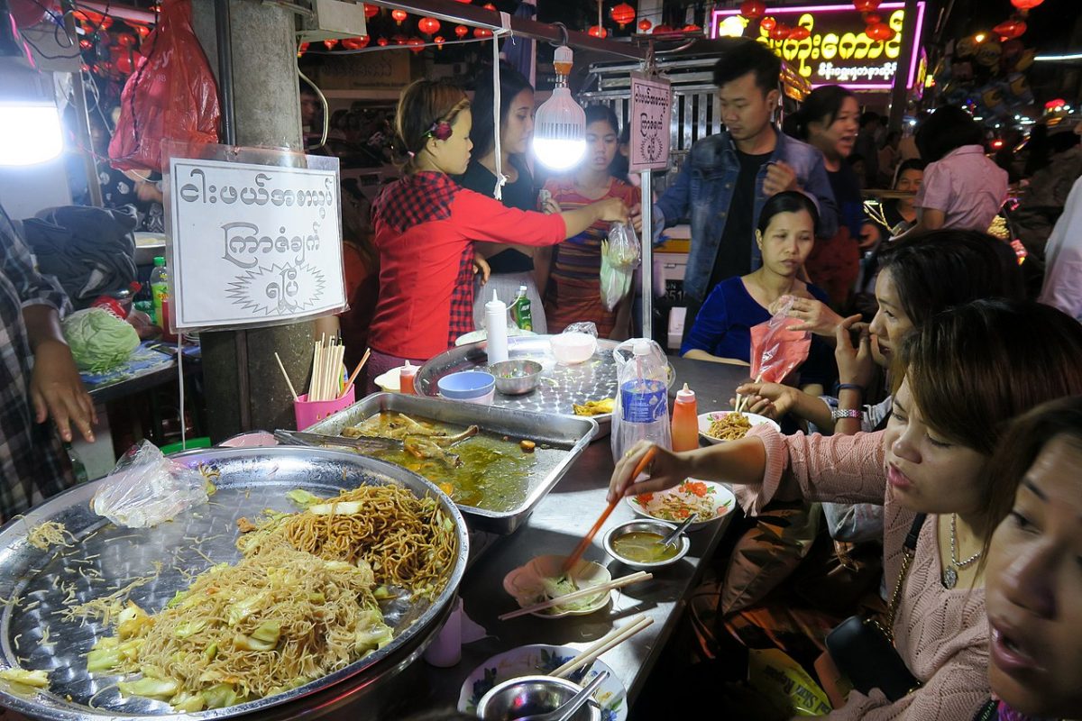 people busy ordering and eating street food at Yangon Chinatown