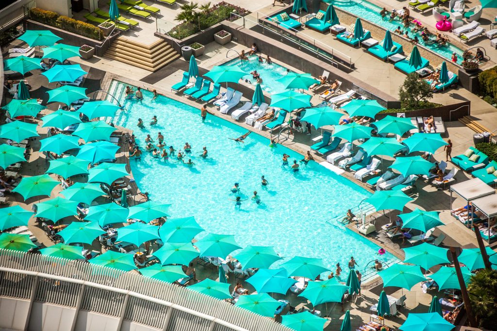 Tourists enjoying a sunny dip in a Las Vegas pool.